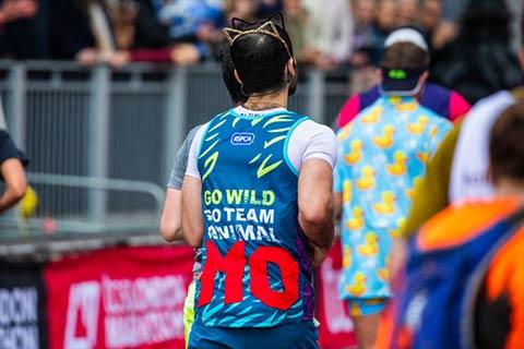 Fundraiser sporting an RSPCA Team animal running vest from behind.