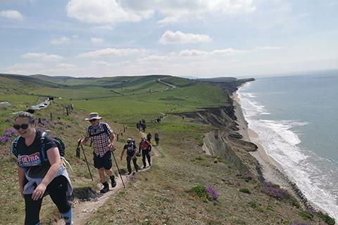 Trekkers walking the coastal path on the Isle of Wight.