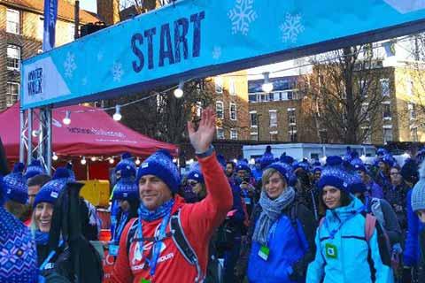 A large crowd of people at the start line of the London Winter Walk trekking event.